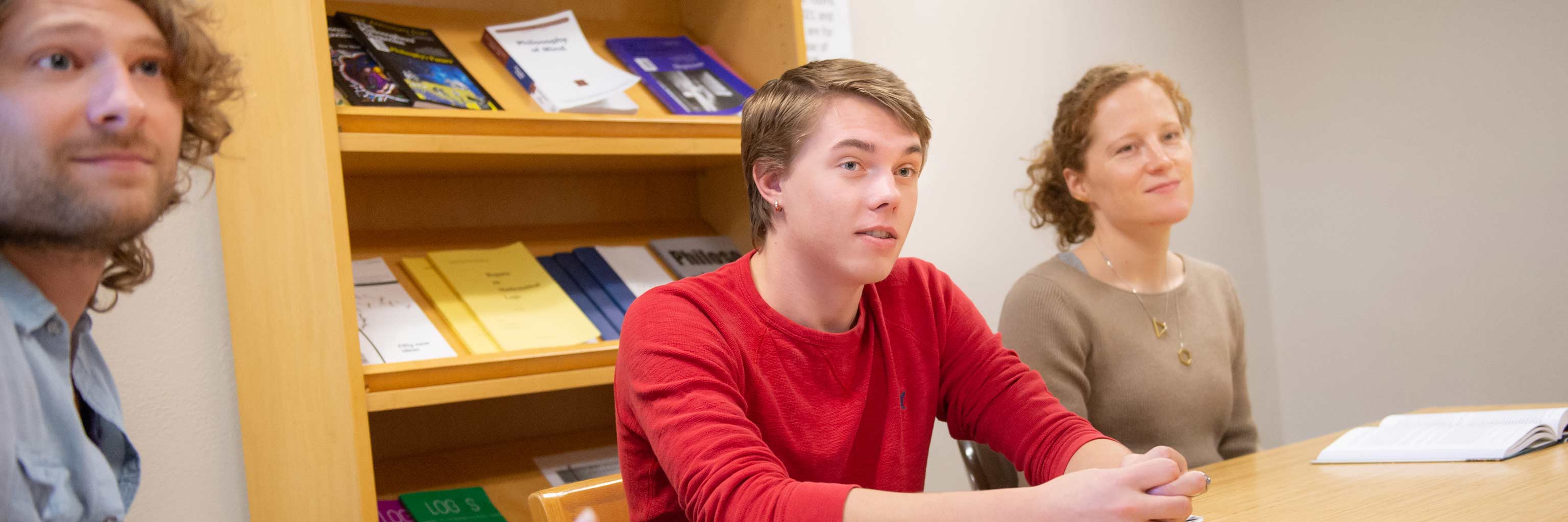 Three students listening during a class lecture.