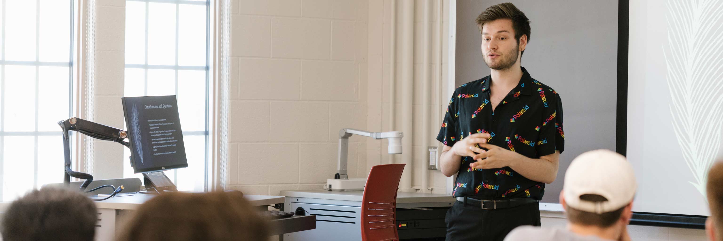 A student delivers a presentation in front of the class.