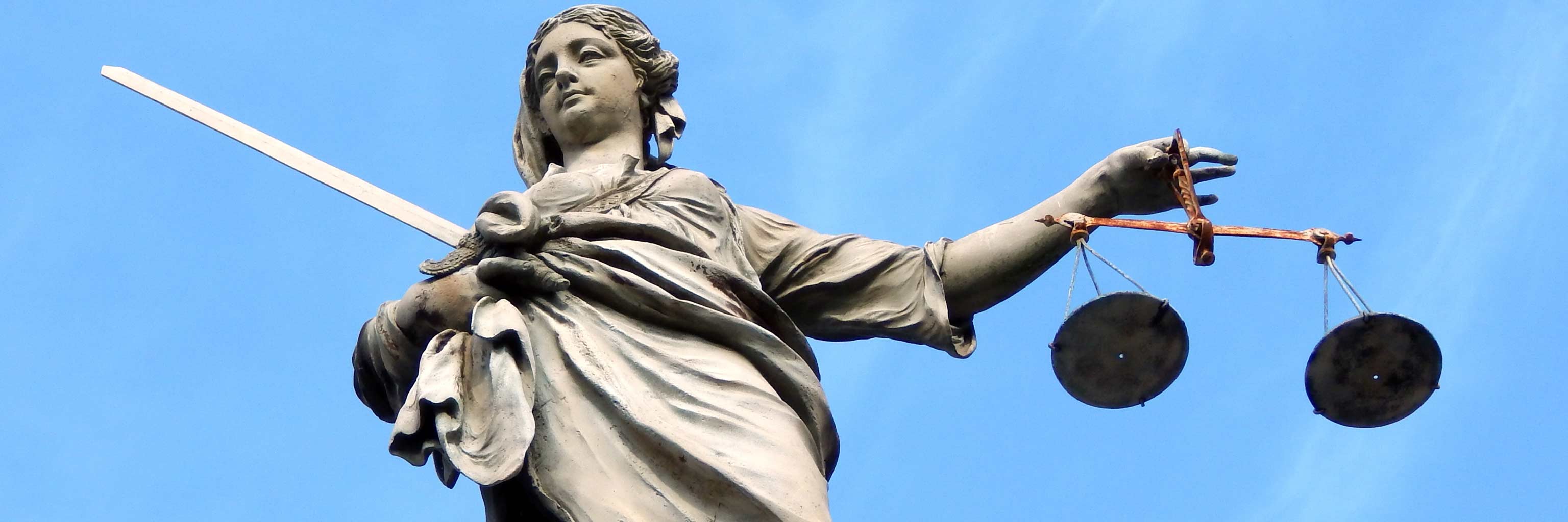 Statue holding a scale of justice.