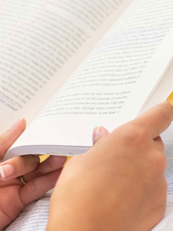 A close-up shot of someone reading a book.